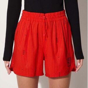 Puma x Vogue Striped Athletic Soccer Shorts in orange size medium